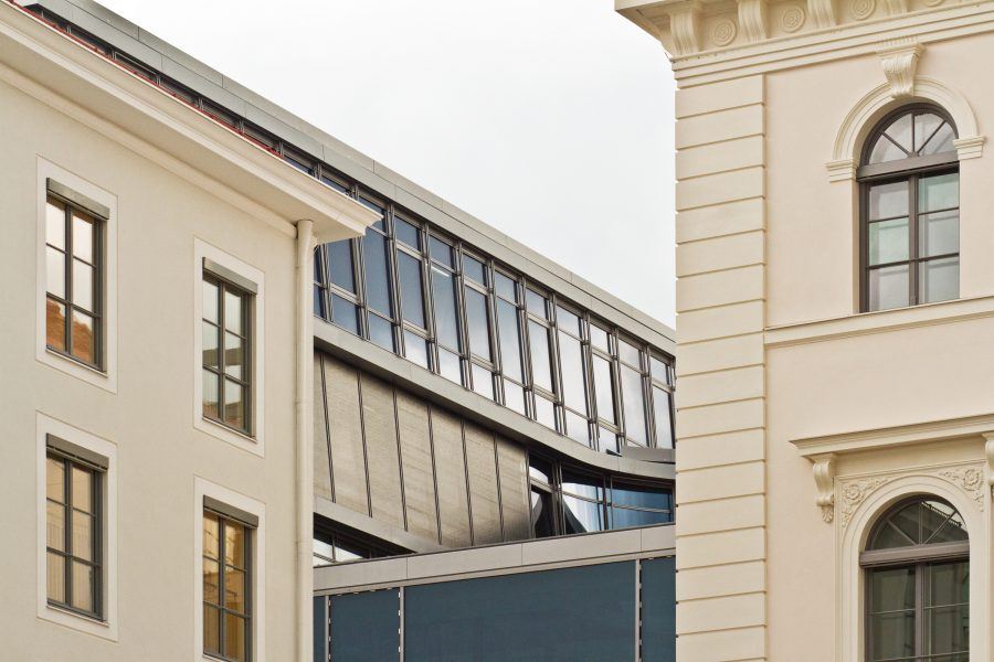 A part of Siemens' building as seen from th angle in between two more classical buildings.