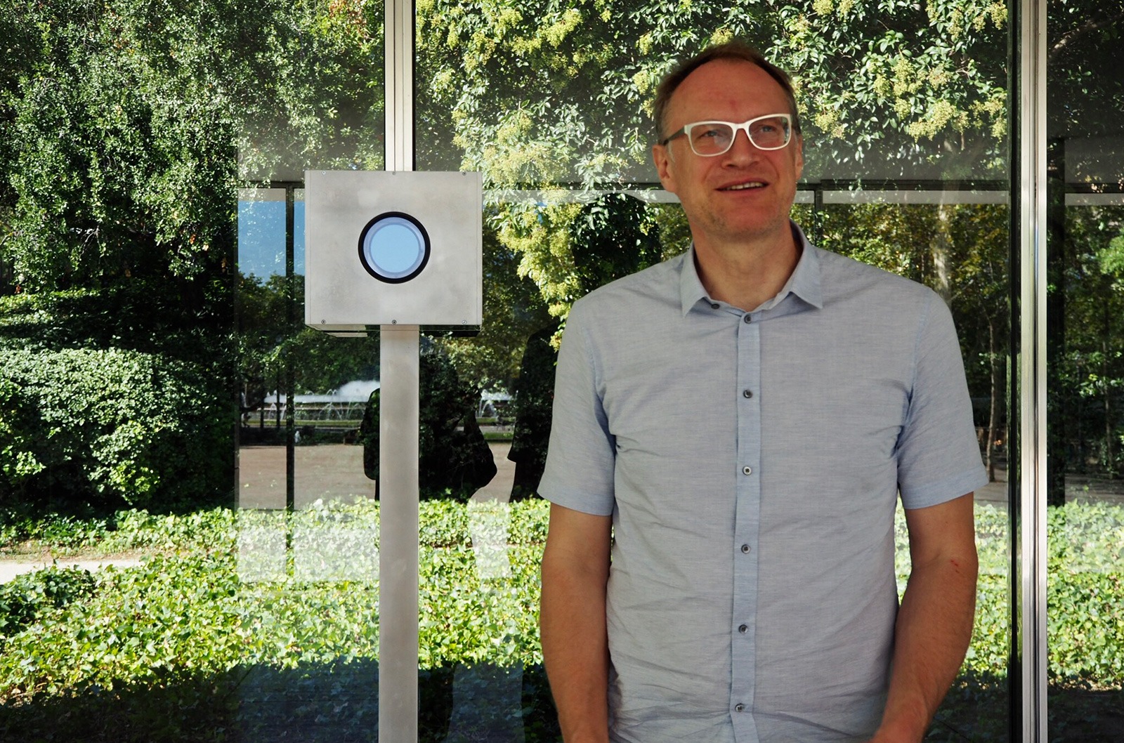 Michael Wesely standing next to his long exposure camera at Mies van der Rohe's Barcelona Pavilion. Copyright: Marta Pérez – Labóh.