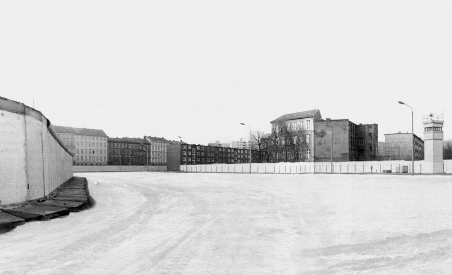 School building behind Berlin Wall strip. 