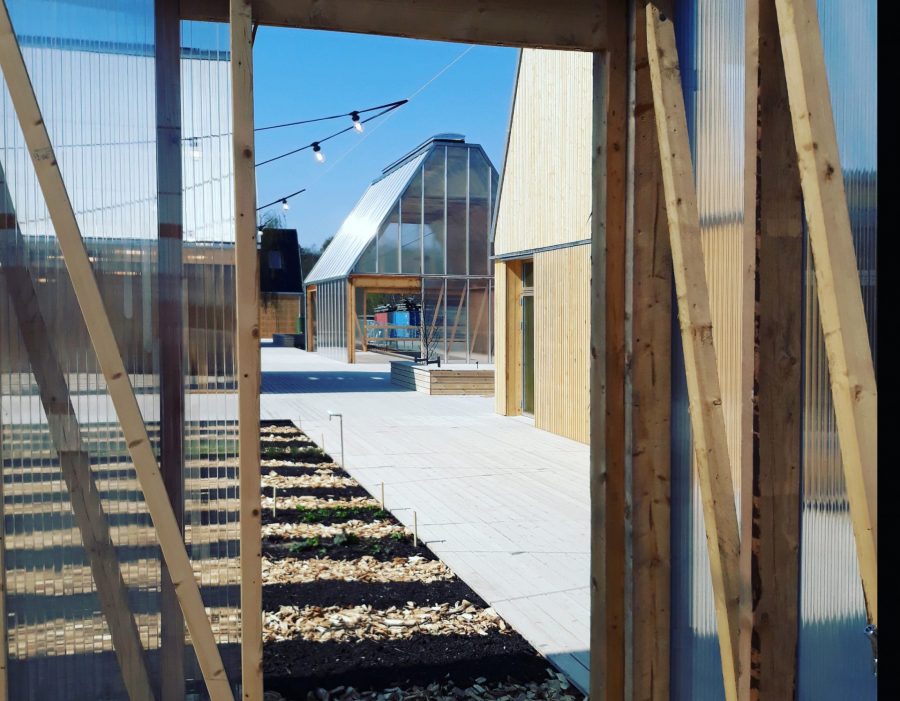Common spaces, such as greenhouses, are used for building community. 