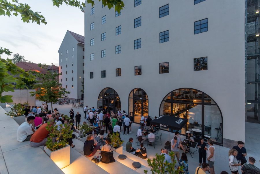 Lively outdoor space: terrace of the café on a summer evening. Photo by: ©Miran KambičBlaz Gutman - industrial monument